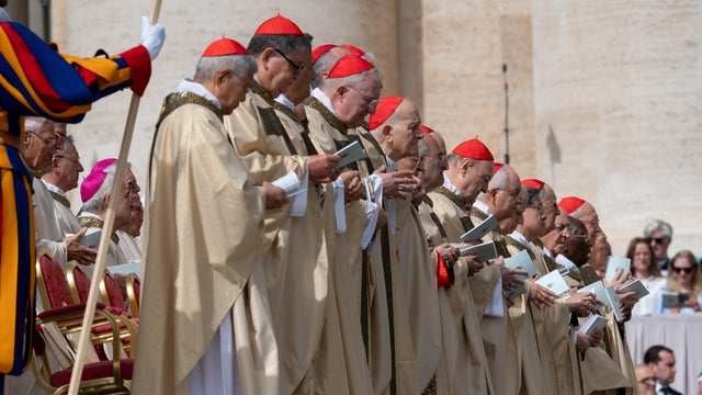 Pope Francis walks with Cardinal Gerald Cyprien Lacroix 