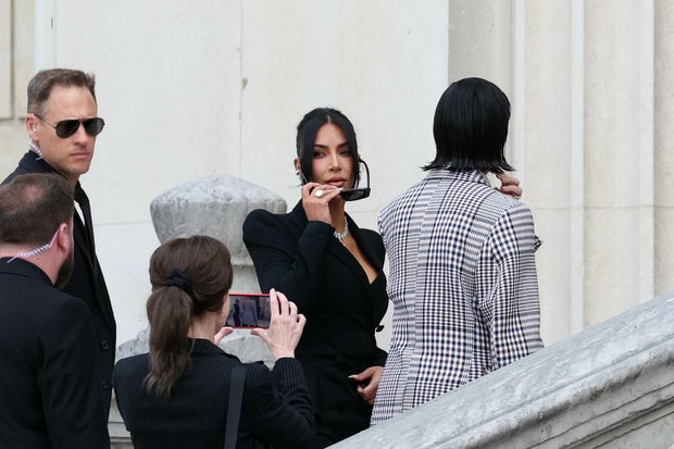 Kim Kardashian, center, arrives at the Assize Court for the trial over the 2016 robbery that saw a gang steal millions of dollars' worth of jewelry at gunpoint, in Paris, France, May 13, 2025. 