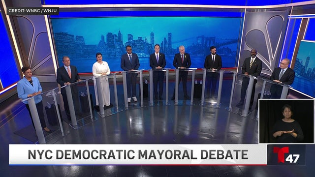 The nine Democratic candidates for New York City mayor stand on a stage. 